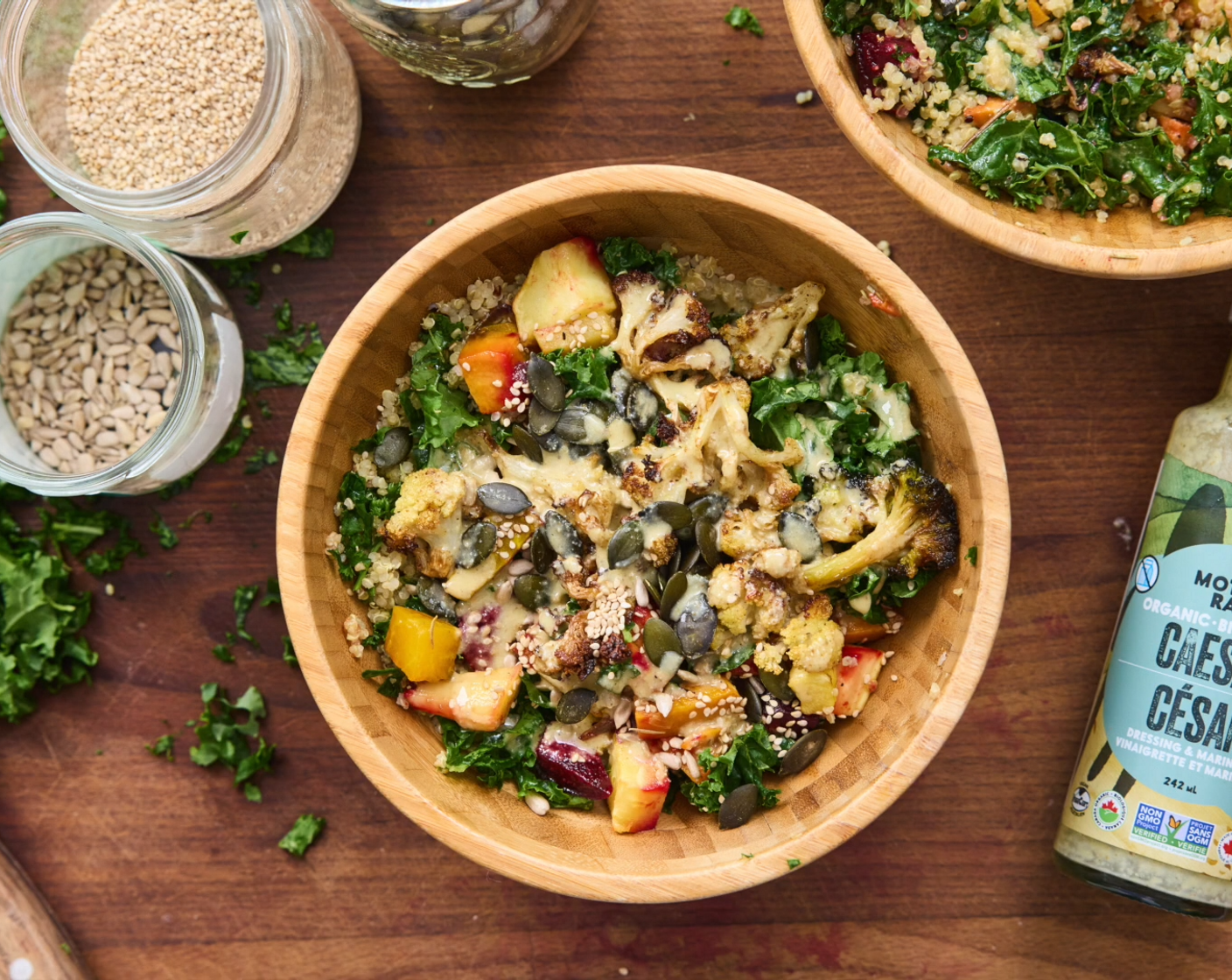 step 8 To serve, divide quinoa into two bowls. Now mix in Kale (2 cups) and Fresh Parsley (1/2 cup) into each bowl. Top with roasted veggies. Pour the desired amount of Caesar Dressing (to taste) into both bowls. I used about 1/3 a bottle for two salad bowls. Top with your Mixed Seeds (to taste).