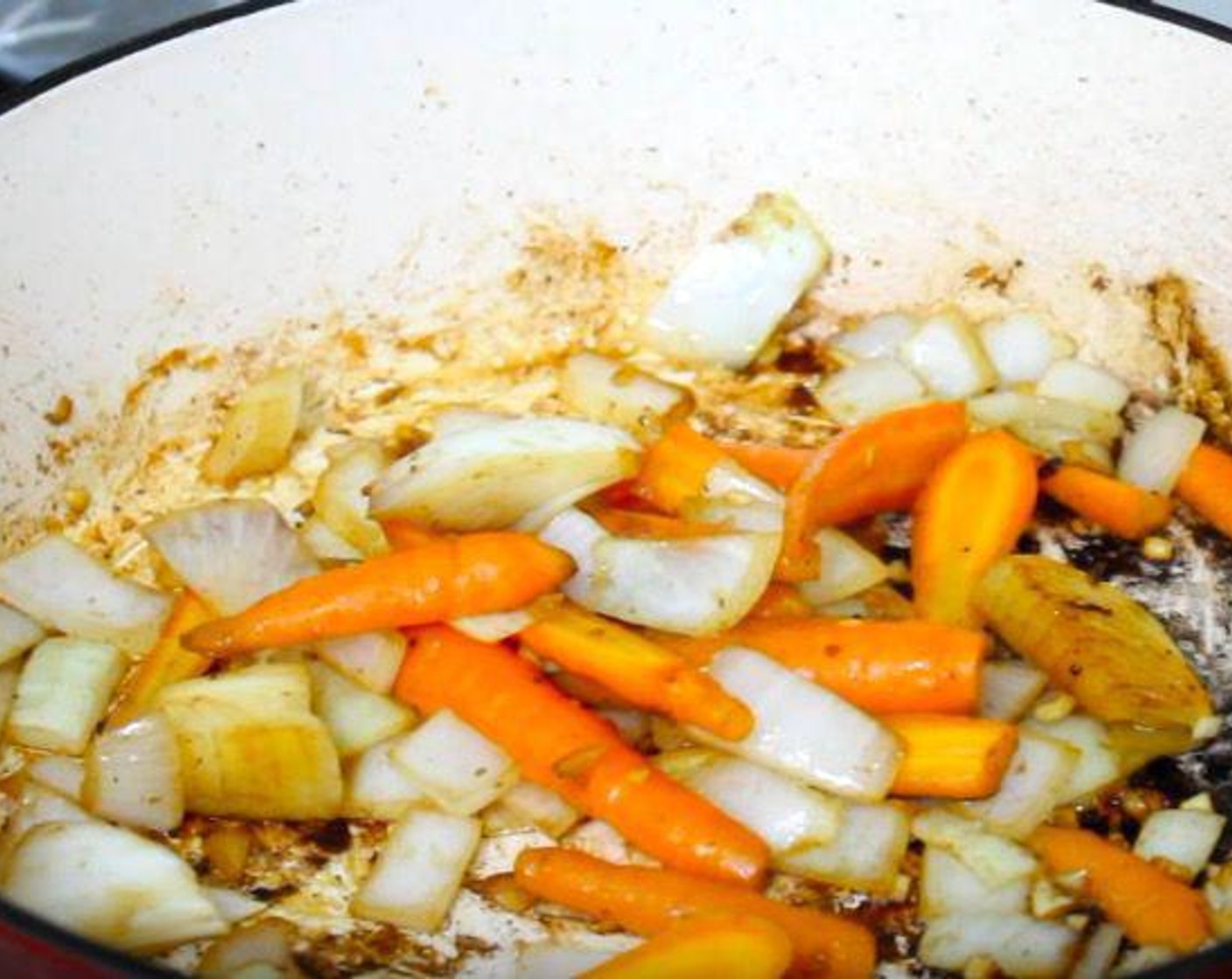 step 3 In the same pan, add Yellow Onion (1), Carrots (2), Garlic (2 cloves), and Celery (2 stalks). Adjust seasonings. Cook until the vegetables start to soften.