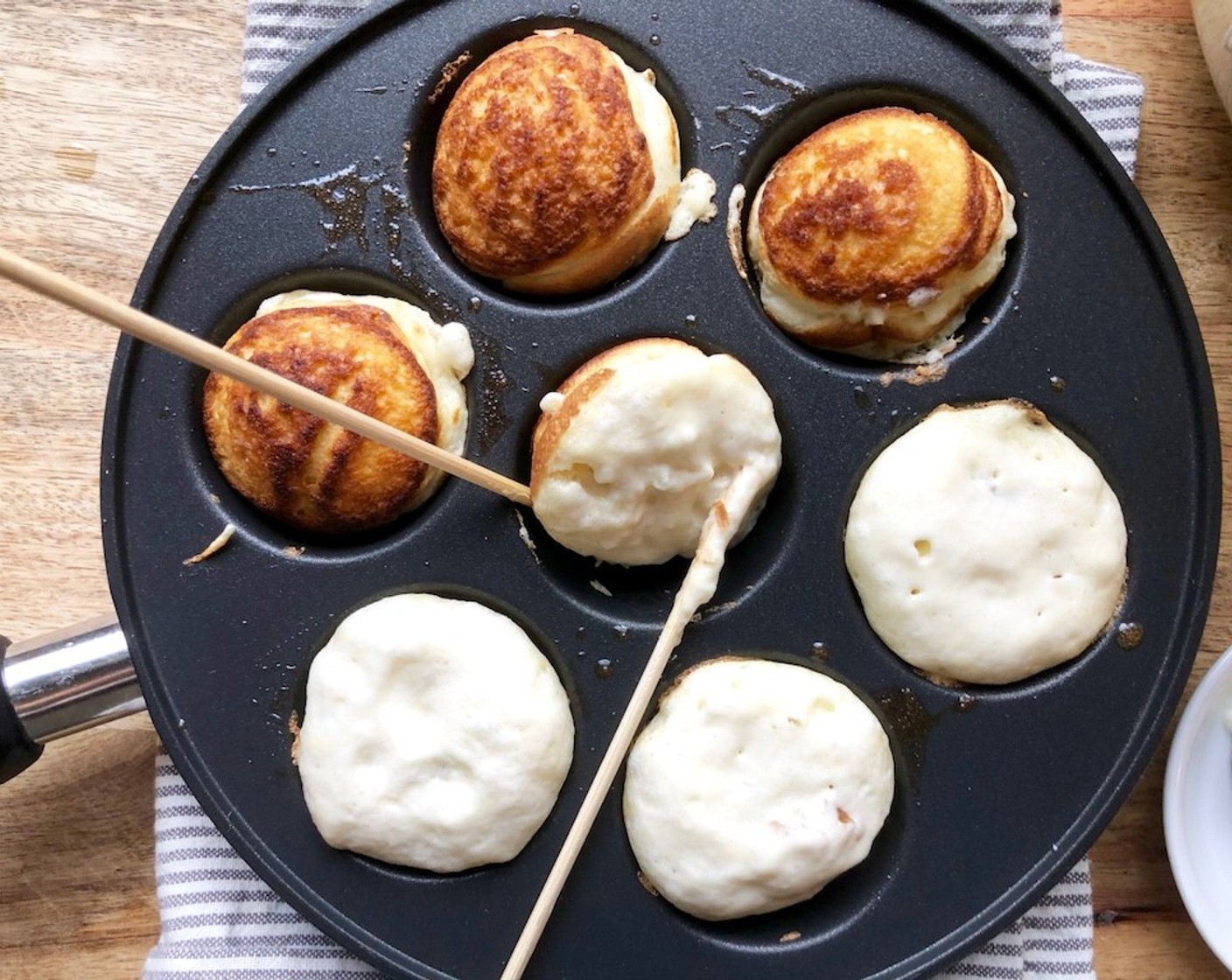 step 9 Using 2 skewers or toothpicks, carefully turn and flip the pancakes over. Cook until golden and crispy, about 3 minutes more.