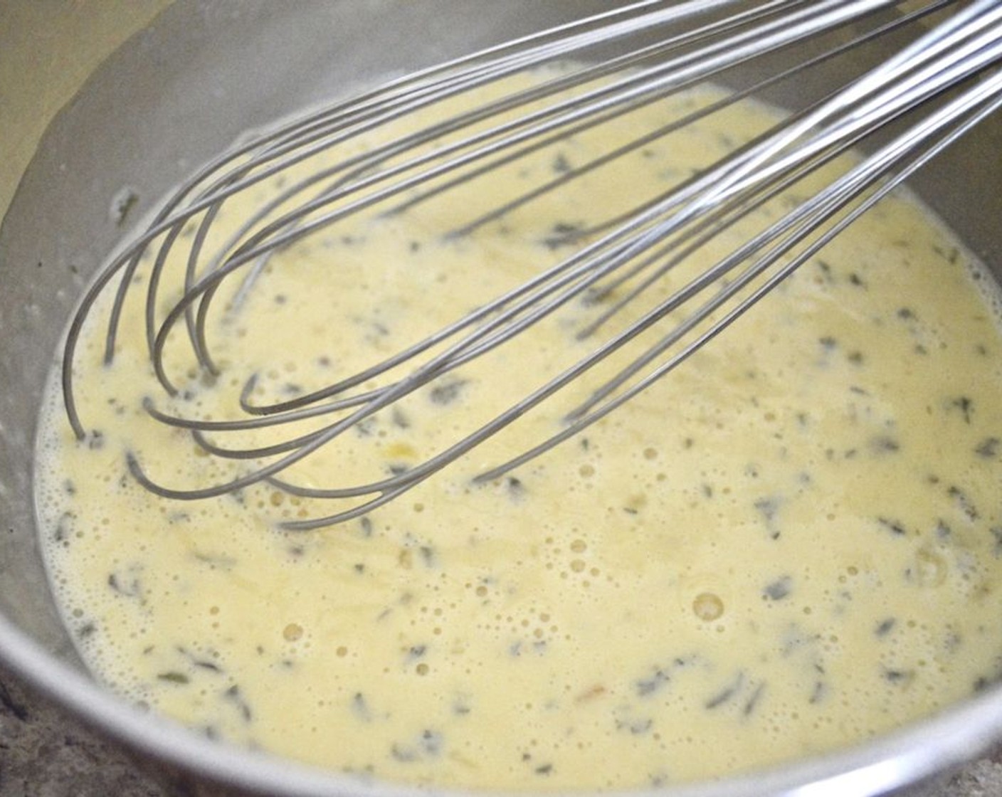 step 3 Whisk the Eggs (8), Milk (1/4 cup), HP™ Sauce (1 Tbsp), Minced Dried Onion (1/2 tsp), Dried Parsley (1/2 tsp), Salt (2 pinches), and Ground Black Pepper (2 pinches) together thoroughly in a bowl, making sure to get some air into it.