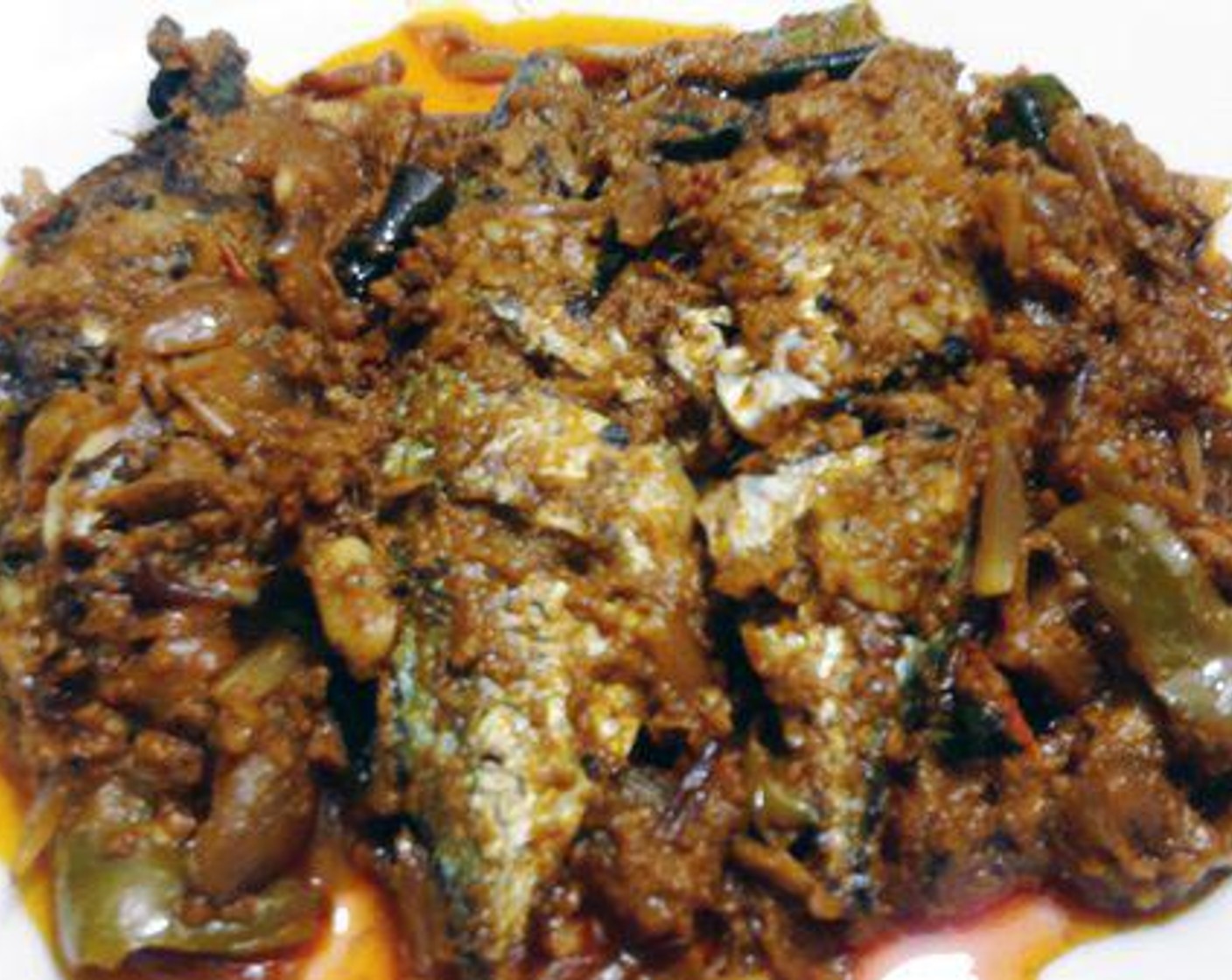step 3 Reduce the flame and add Ground Turmeric (1/4 tsp), Red Chili Powder (1 tsp), Garam Masala (1 tsp), and Ground Coriander (1 tsp). Mix well and saute it again for four to five minutes in slow flame. When the masala blends in well pour the Coconut Milk (1 cup), add Curry Leaves (to taste) and Salt (to taste). Let the gravy boil till it becomes very thick.(you can see oil coming out). Once the gravy becomes thick, add the fried fish.
