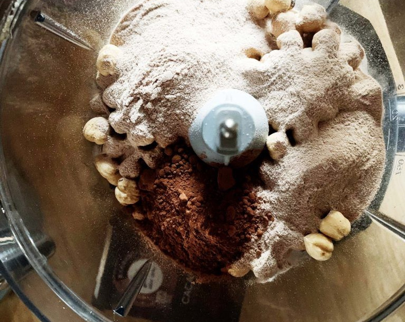 step 1 Place Hazelnuts (2 cups), Chocolate Whey Protein Powder (2 scoops) and Unsweetened Cocoa Powder (2 Tbsp) into a food processor.