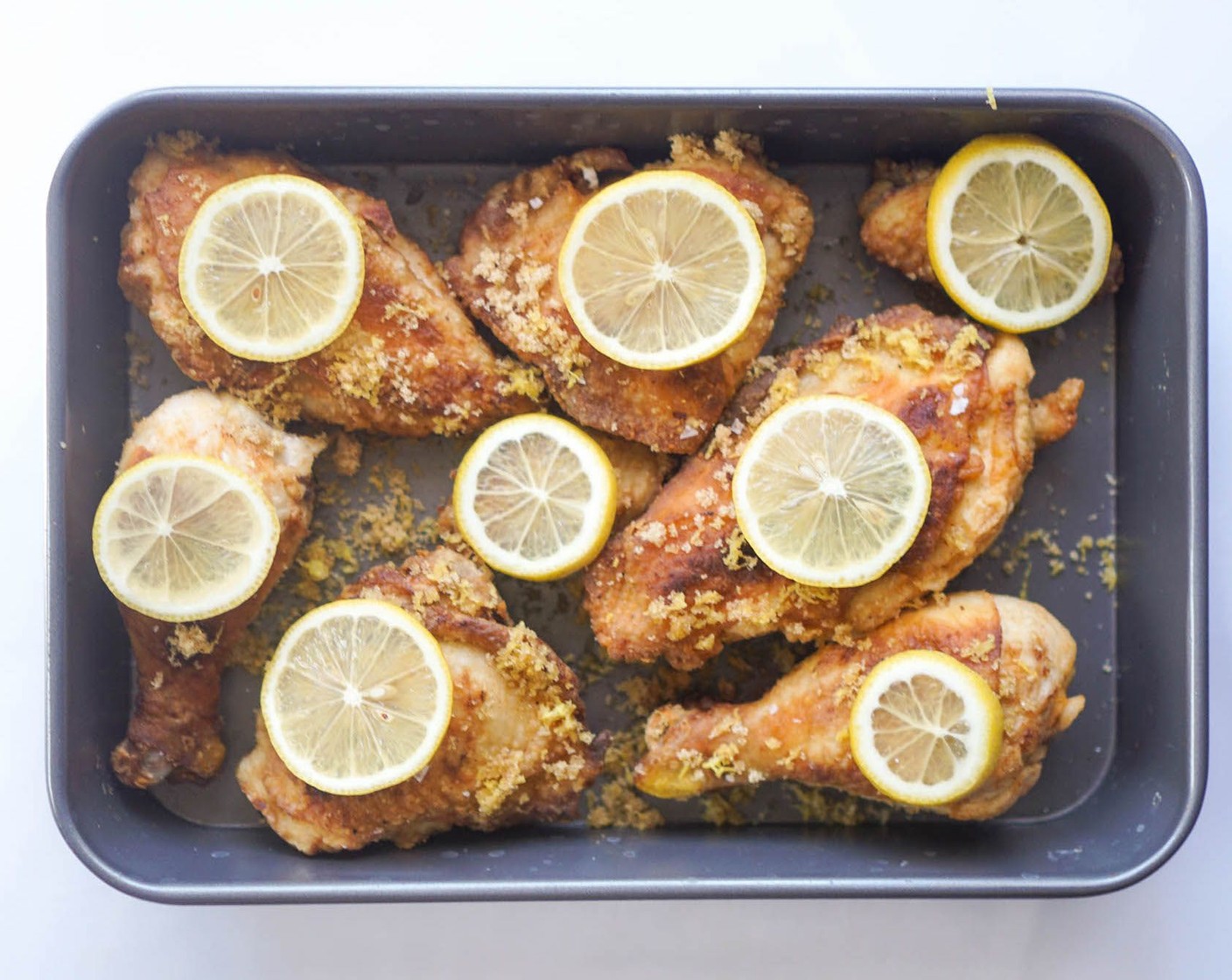 step 9 Mix the Lemon Extract (1 tsp) and Chicken Stock (1/4 cup) and pour around the chicken pieces. If using White Wine (1 splash), add a splash or two. Set a thinly sliced Lemon (1) on top of each piece of chicken.