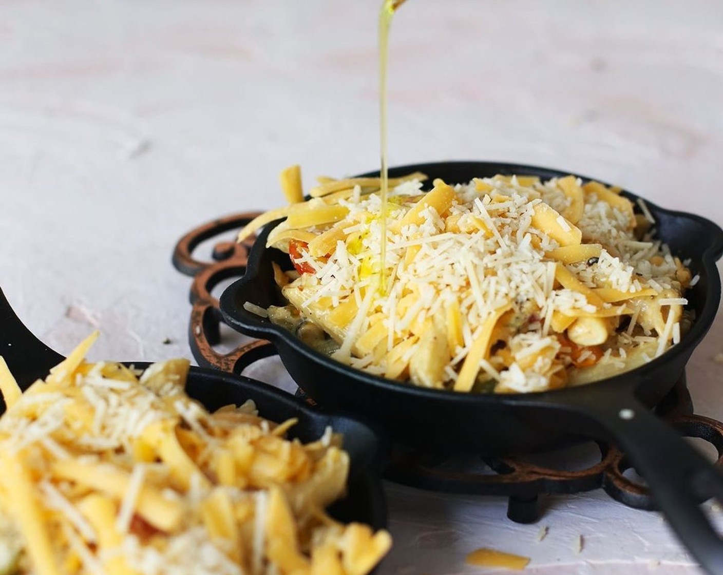 step 6 Pour pasta into 4 oven-safe bowls, top evenly with Shredded Cheddar Cheese (1 cup) and Shredded Parmesan Cheese (3/4 cup) and drizzle with Olive Oil (as needed). Place under the broiler on low until melted.