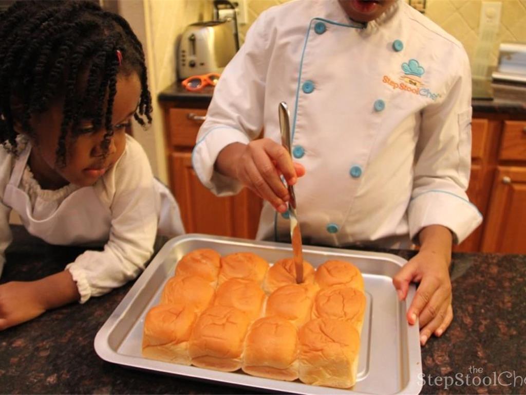 Step 2 of Pull Apart BBQ Chicken Sliders Recipe: Make diagonal slit on top of each Dinner Roll (12).