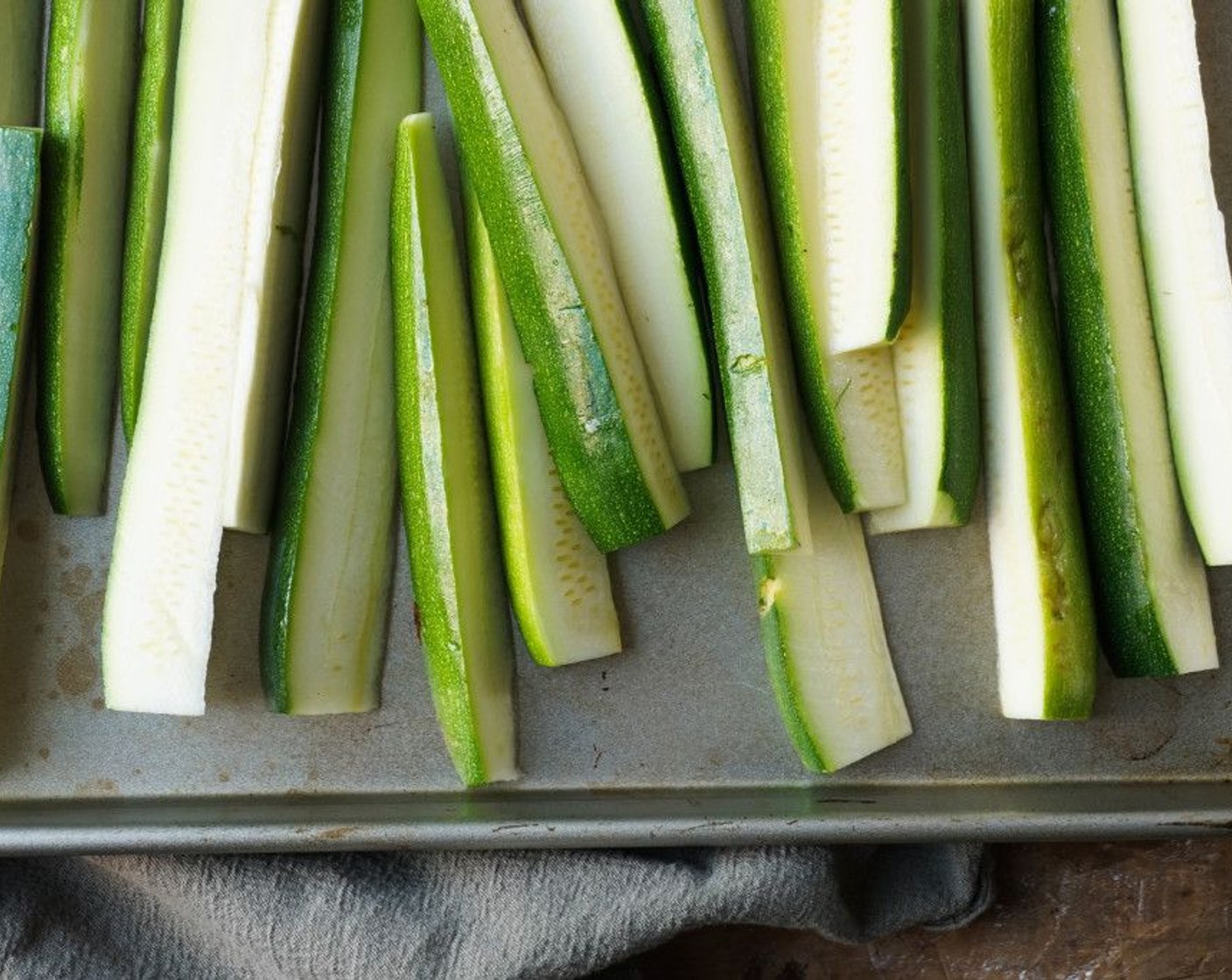 step 2 Cut the ends off the Zucchini (3), then cut in half length wise. Cut each half into half once more, then repeat to create 8 long spears. You can cut those in half width wise to yield smaller fries, but I do not recommend making them any smaller.