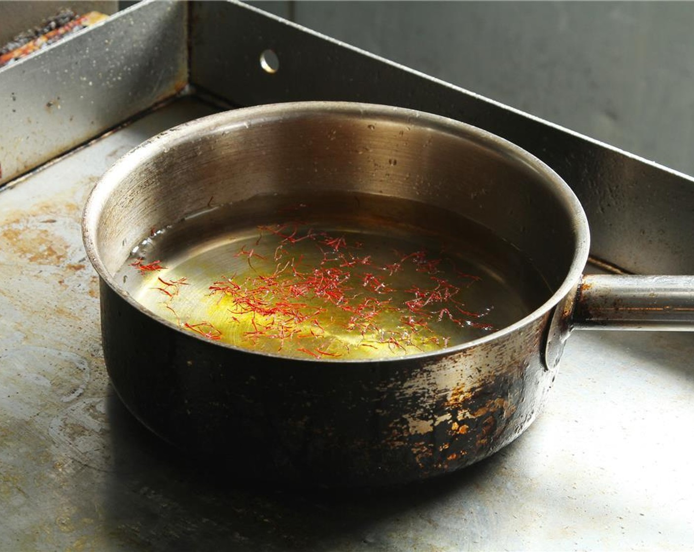 step 8 In a pot, add cold Water (3 Tbsp) and Saffron Threads (1 pinch). Bring it to simmer, then remove from heat. Heat Lobster Stock (3 3/4 cups) and set aside.