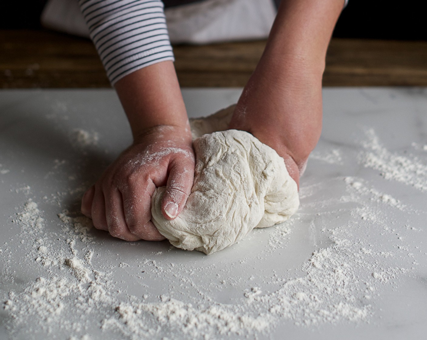 step 2 Using hands, mix the water into the flour until it forms a dough. Turn out onto a floured surface and knead until smooth.