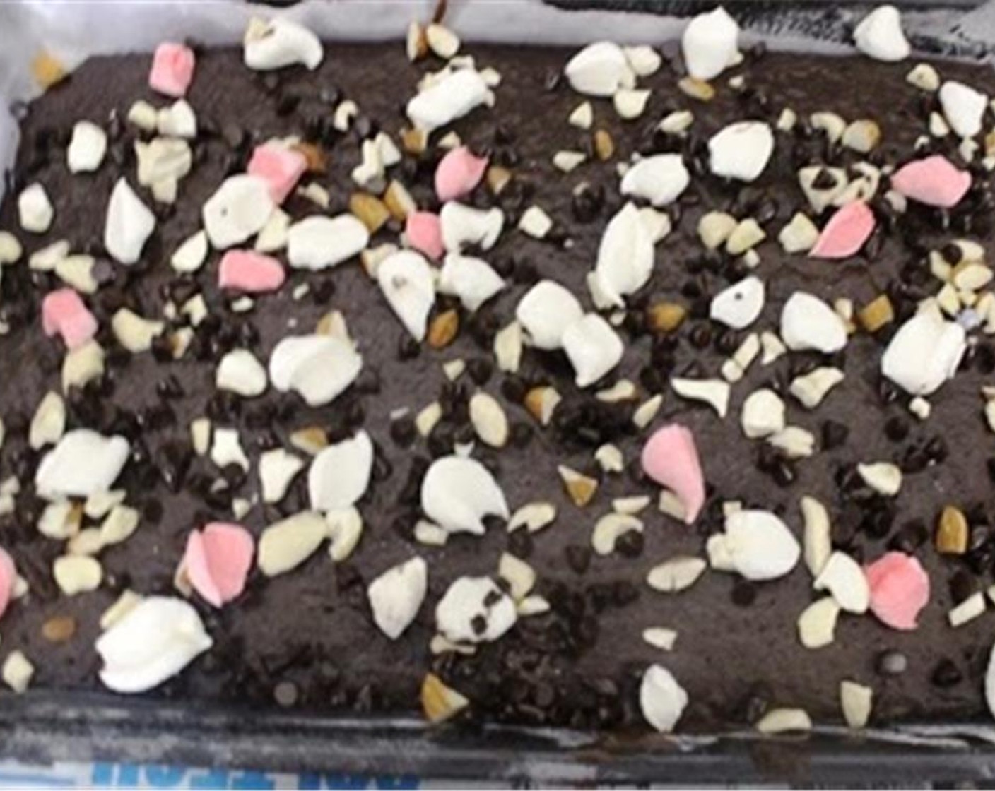 step 5 Remove from the oven and immediately top with Assorted Nuts (4 Tbsp), Milk Chocolate Chips (4 Tbsp), and Marshmallow (1/2 cup).