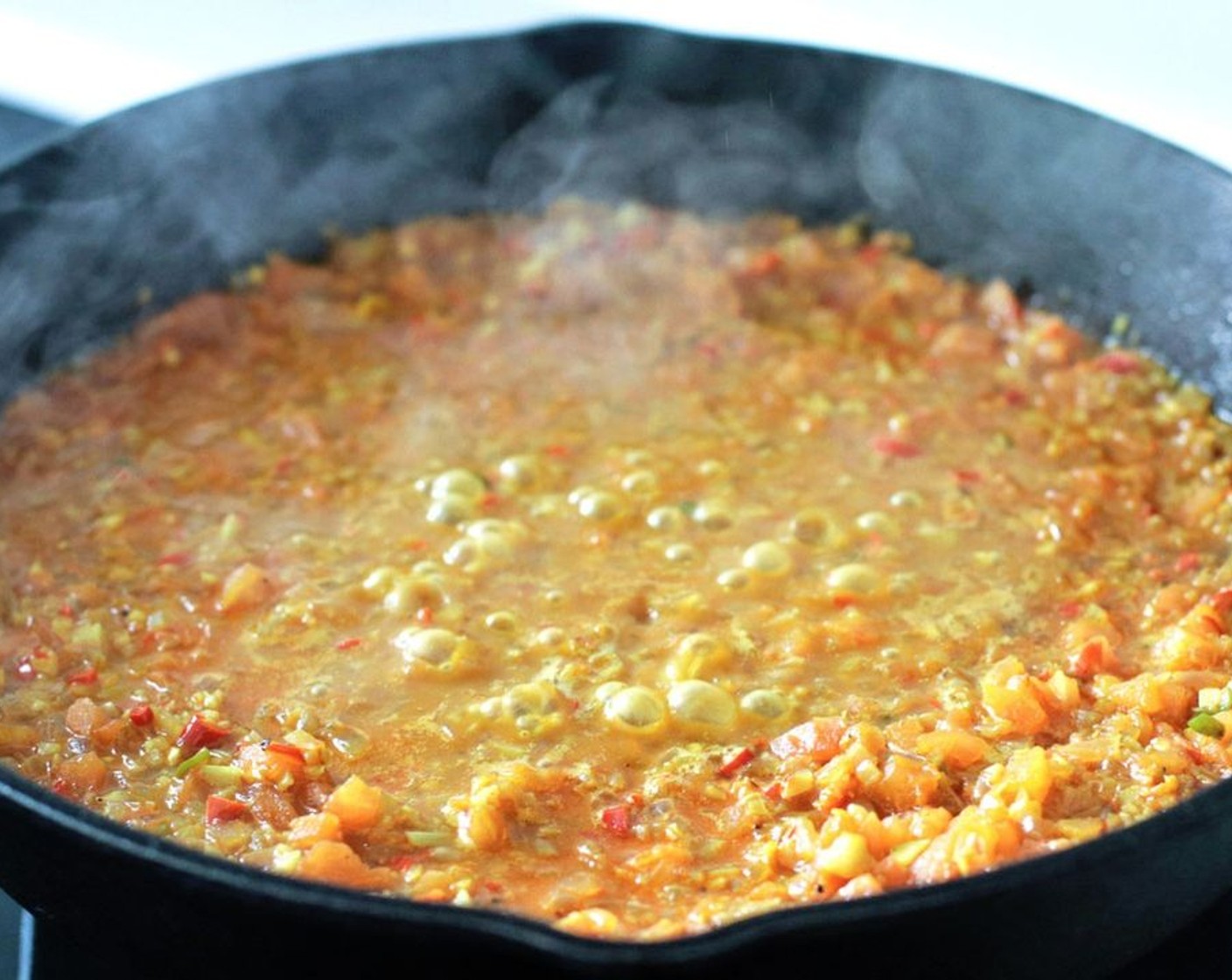 step 8 Add the Tomatoes (2) and pour in the Water (1 cup). Stir, and then turn down the heat to low and cover the pan. Simmer for 5-6 minutes.