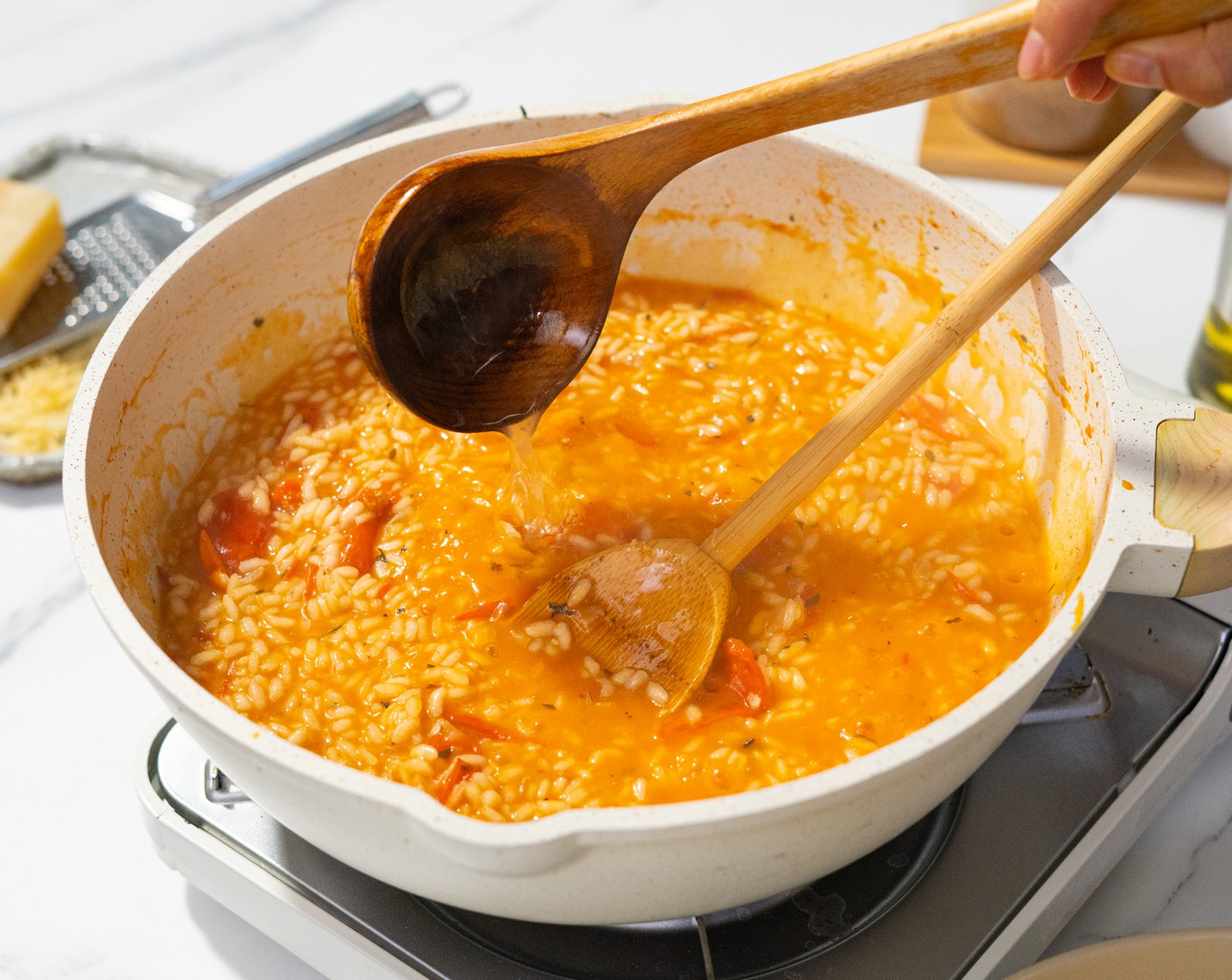 step 6 Turn heat to medium-low. One ladle at a time, add the warm Chicken Broth (5 cups). Cook, stirring frequently until liquid is absorbed. Continue adding stock like this until the rice is cooked to al dente and the risotto is at a runny, almost soupy texture (it will thicken with the cheese).