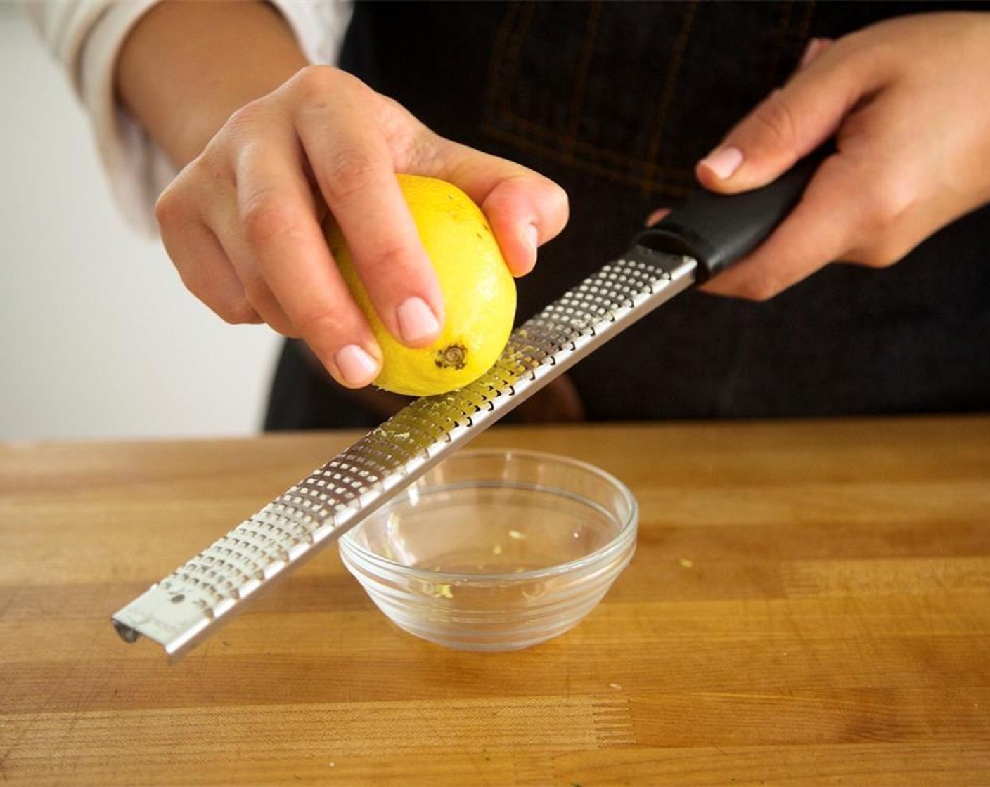 step 4 Zest and juice Lemon (1) into small bowl and remove any seeds with a fork. Hold.