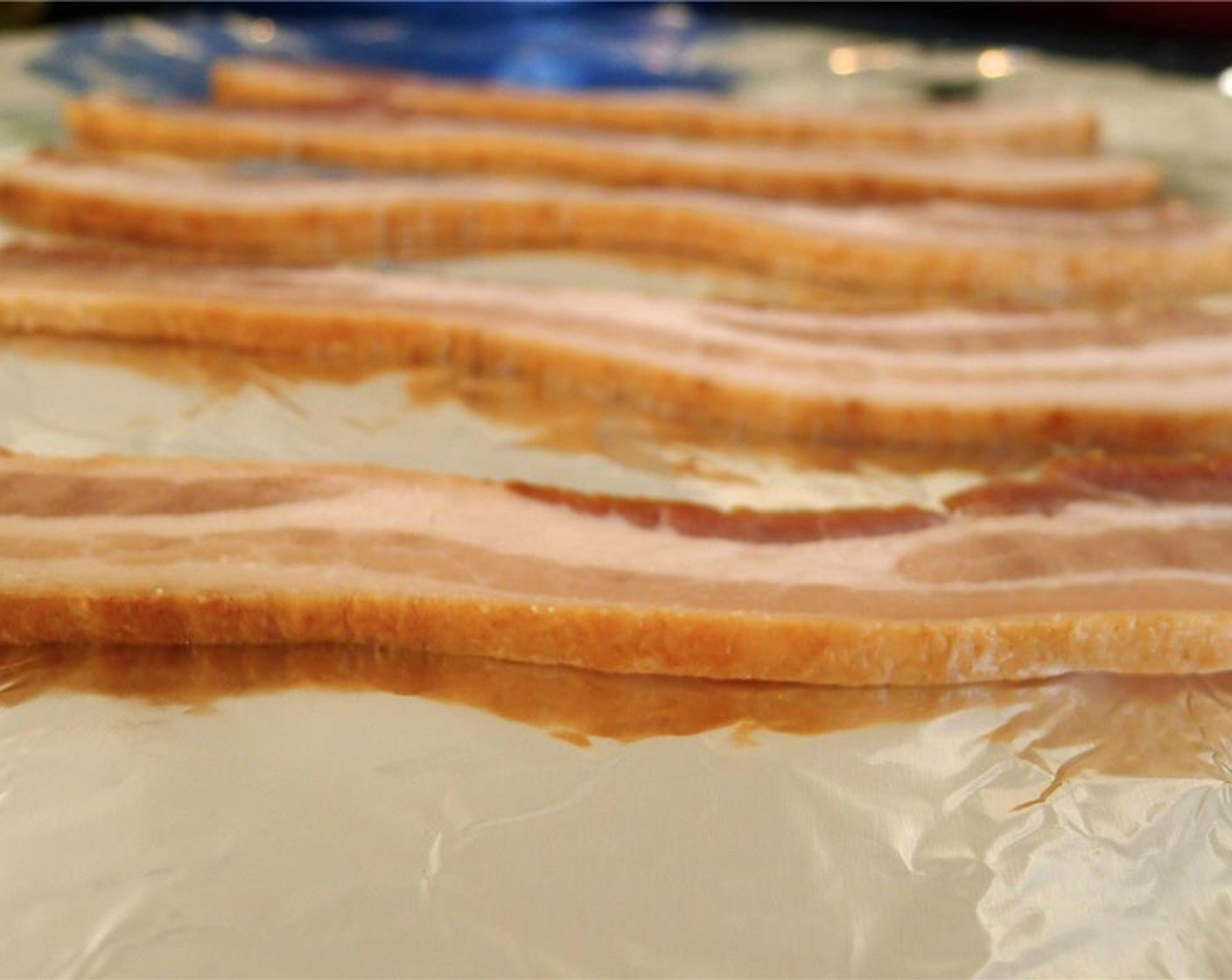 step 3 Bake bacon at 350 degrees F (180 degrees C) in the oven for 20 minutes, or until crisp. Set aside on paper towels until cool.