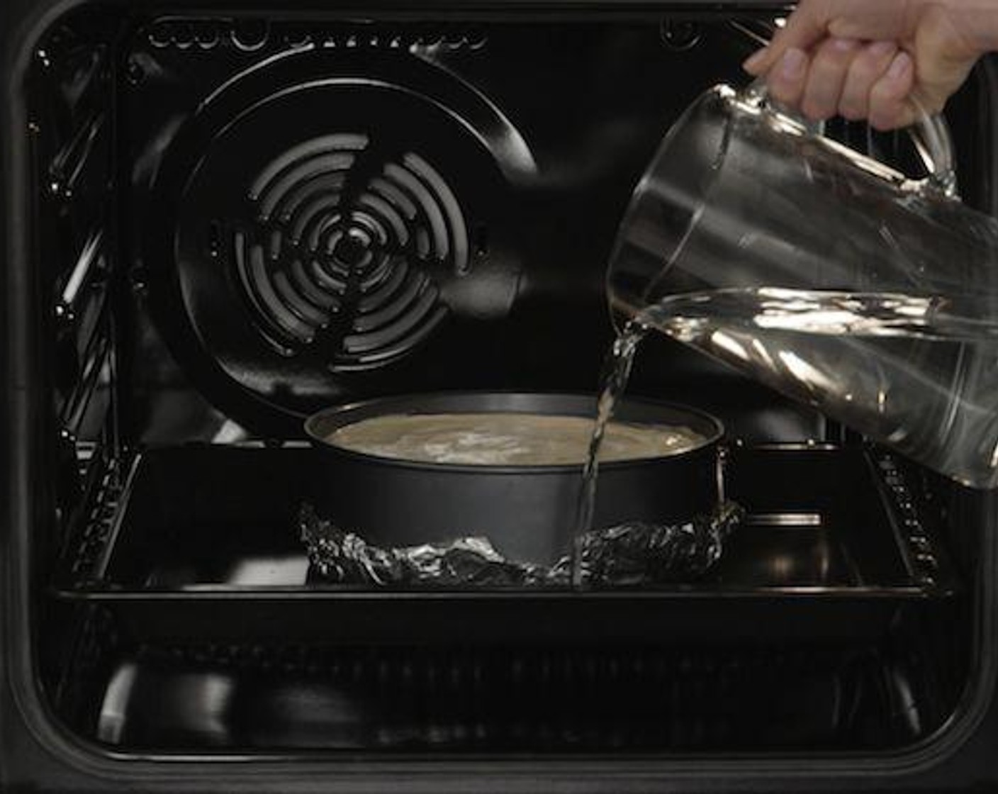 step 6 Place a cooking tray on the lowest shelf position. Wrap the baking pan with aluminum foil. Steam ovens are ideal for fluffy cakes but your conventional oven can produce great results too. Just pour water around the form, around 2.5-cm deep. This helps the cake rise better while ensuring a fluffier, softer texture.