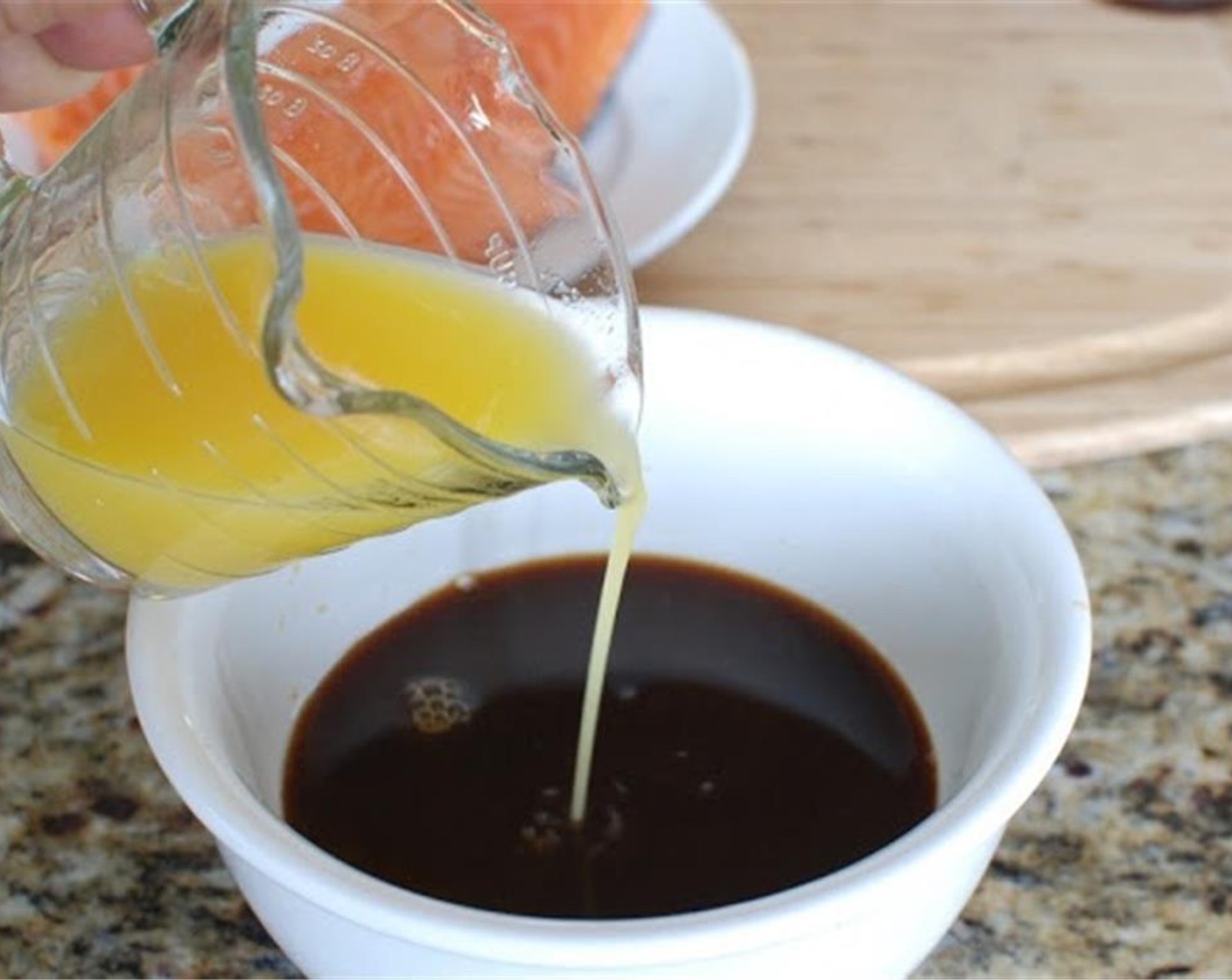 step 1 Slice the Onion (1) and place it in the baking dish with the Salmon Fillets (4). Whisk the Oranges (2), Soy Sauce (1/2 cup), Honey (1/2 cup), Simply Organic Garlic Powder (2 tsp) and Ground Ginger (2 tsp) together and pour over the salmon.