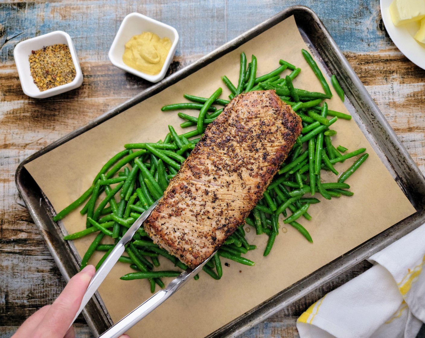 step 7 Remove the pork loin from the pan and place them on top of the green beans. Put the sheet pan into the oven and roast for 40 minutes, turning the pork halfway.