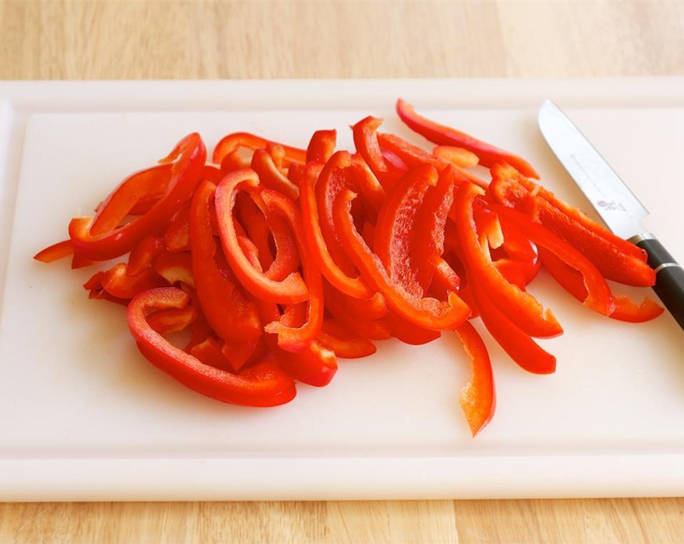 step 2 Thinly slice the Red Bell Peppers (2). Mince the Garlic (2 cloves). Chop the Fresh Cilantro (1 bunch).