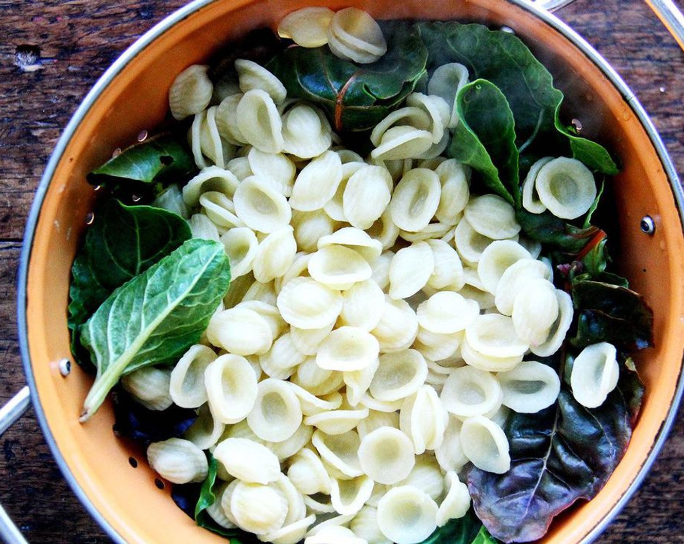 step 6 Boil pasta till al dente. Reserve 1/2 cup of the cooking liquid and set aside. Drain pasta directly over the colander filled with the greens.