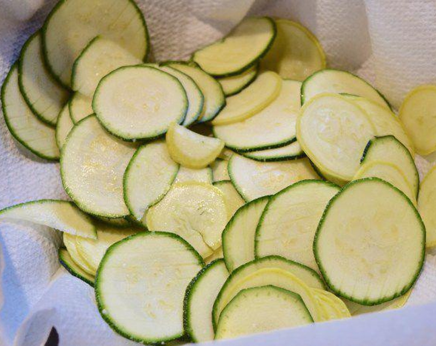 step 2 Place the Zucchini (1) and Yellow Squash (1) on paper towels and season them with a generous sprinkling of salt.