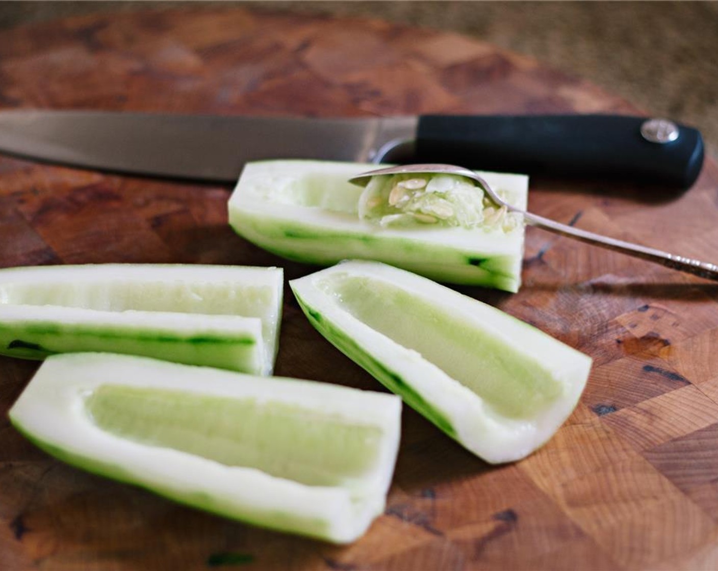 step 9 To make the Tzatziki, peel the cucumber, slice it in half lengthwise, and scoop out the seeds.