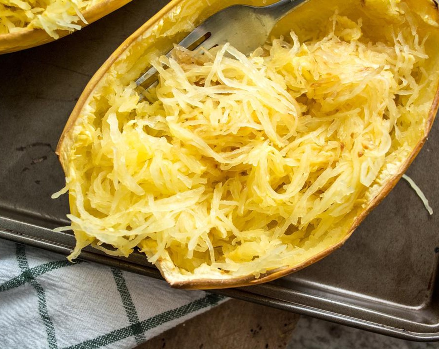 step 2 Cut Spaghetti Squash (1) lengthwise, remove seeds and add to cookie sheet faced down. Bake for 45-50 minutes or until flesh can be combed with a fork and has a pasta-like texture. Set aside to cool.