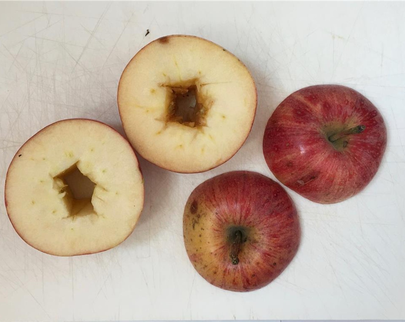 step 3 Core the bottom halves. You can use an apple corer if you got one or a sharp knife. Make sure the apples stay in one piece.