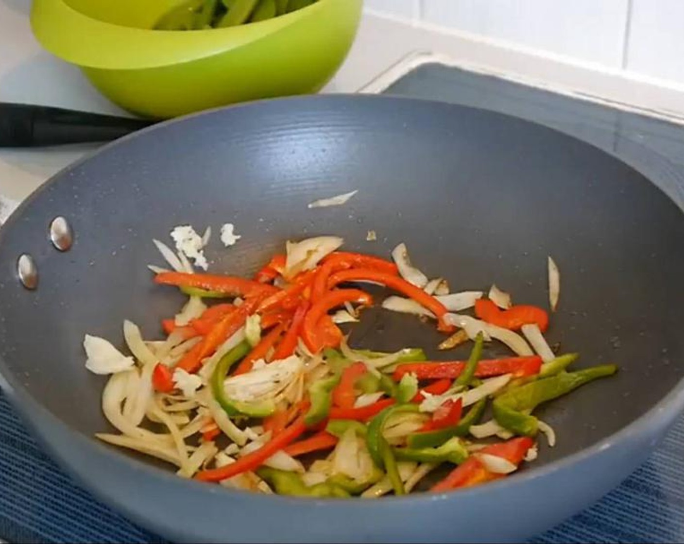 step 2 In the same pan add the White Onion (1/2) and Green Bell Pepper (1/4), stir and leave to cook for a couple of minutes