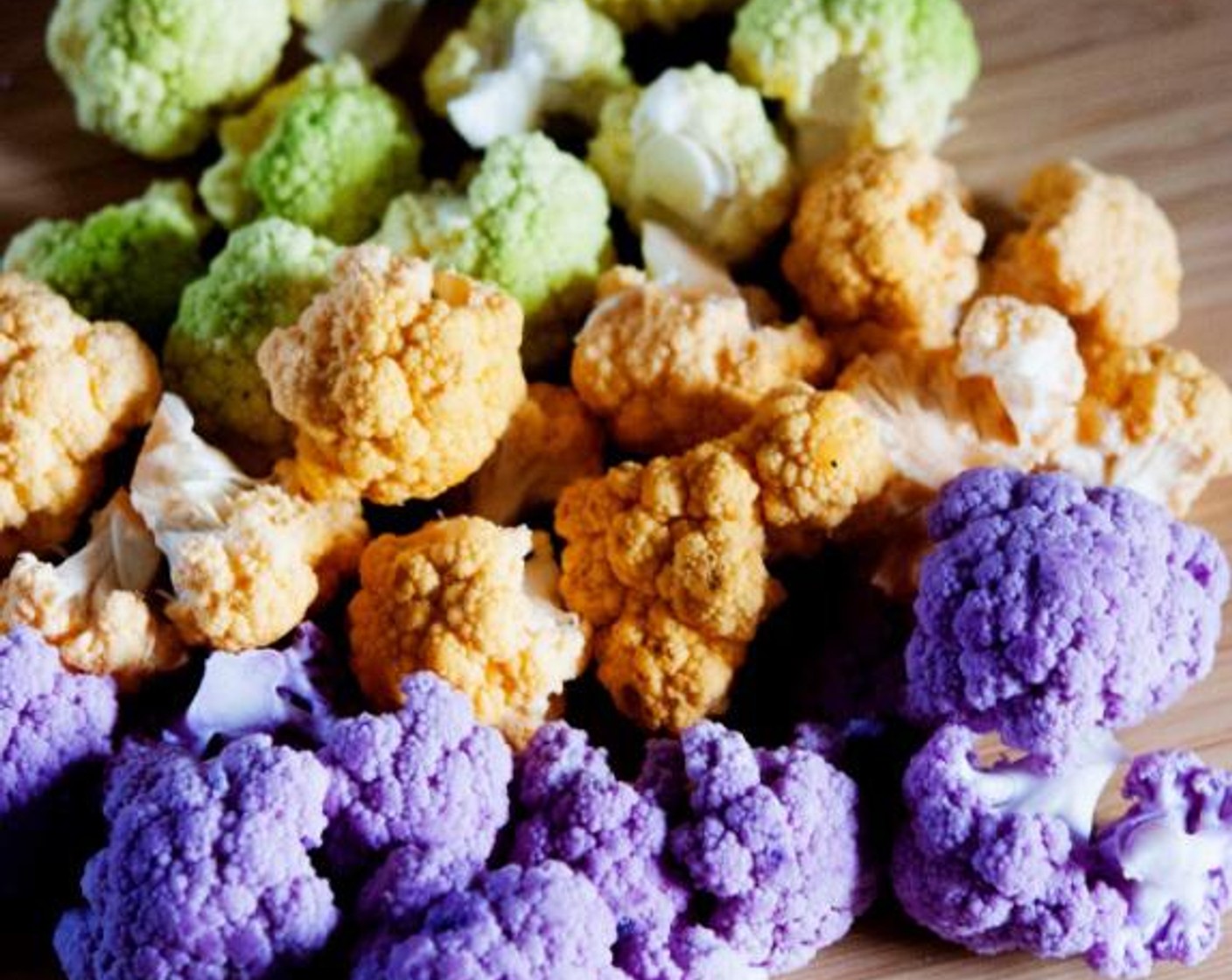 step 1 Start by cutting up the Green Cauliflower (1 head), Orange Cauliflower (1 head), and Purple Cauliflower (1 head) into florets and washing them under running water.