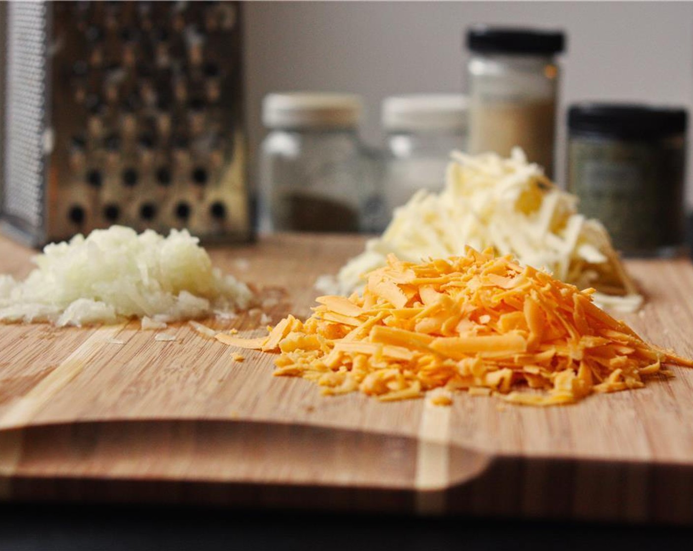 step 6 Grate the Sharp Cheddar Cheese (3/4 cup) and Asiago Cheese (3/4 cup).