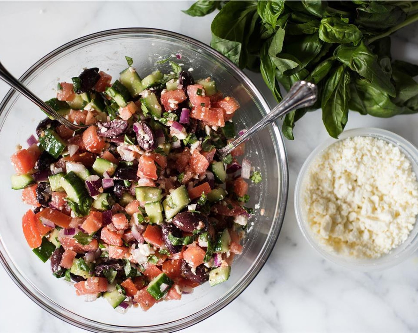 step 3 In a large bowl toss the tomatoes, cucumber, Garlic (1 clove), Red Onion (1/2), and Kalamata Olives (1/2 cup), Feta Cheese (1/2 cup), and Fresh Basil (1/4 cup).