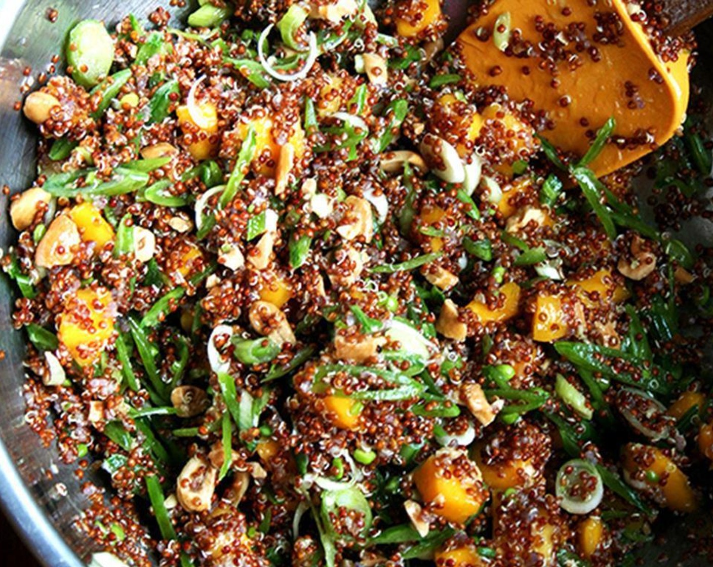 step 4 Place the quinoa into a large bowl. Season with Kosher Salt (to taste) and Ground Black Pepper (to taste). Add peas, cashews, scallions, serrano chili, ginger, Extra-Virgin Olive Oil (1/3 cup), and juice of the Limes (2). Toss and taste. Adjust seasoning as necessary.