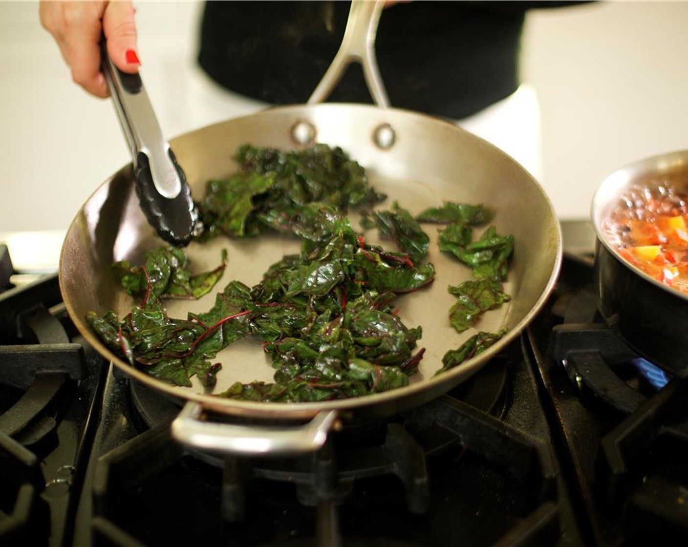 step 9 In the same saute pan, heat Olive Oil (1 Tbsp) over medium-high heat. When hot, add the Chard (4 3/4 cups) and saute for 2 minutes. Season with Salt (1/4 tsp) and Ground Black Pepper (1/4 tsp). Stir and remove from heat.