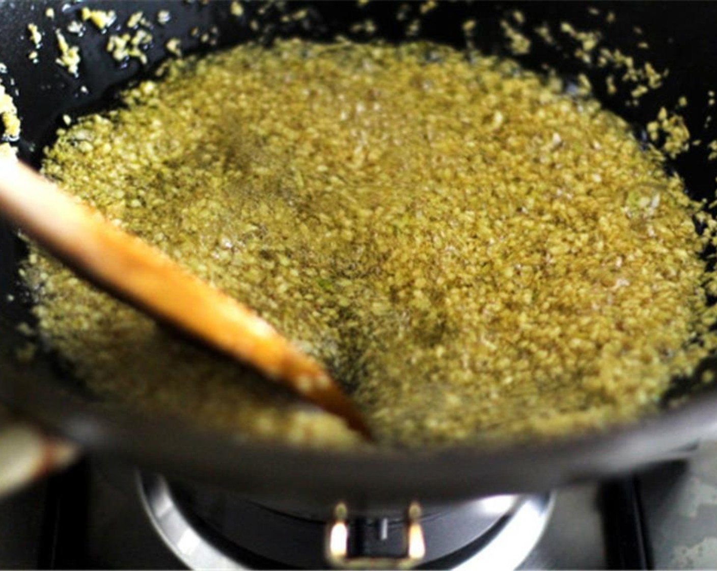 step 3 Lower the heat down to medium, then add all the garlic at once. Keep stirring with a wooden spoon until the garlics start to turn into pale-golden. Turn off the heat completely at this point, and keep stirring with the residual heat.