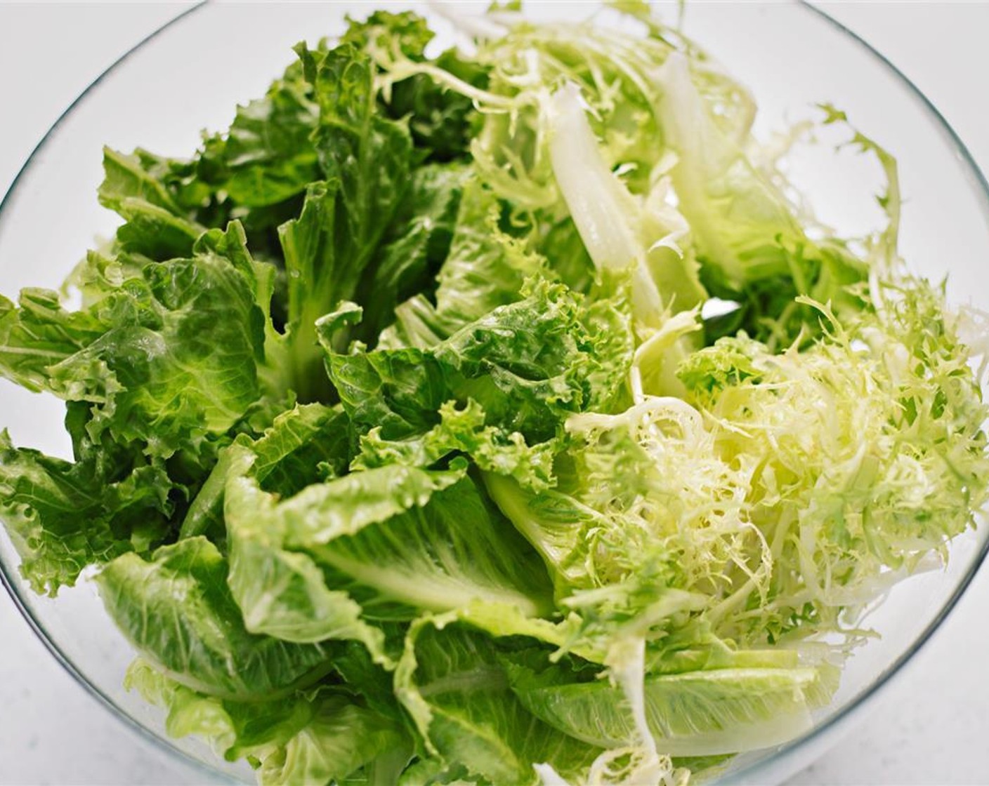 step 2 Tear the Curly Endive (1 bunch), Butter Lettuce (1 bunch), Romaine Lettuce (1 bunch), and Lettuce (1 bunch) into pieces and put in bowl.