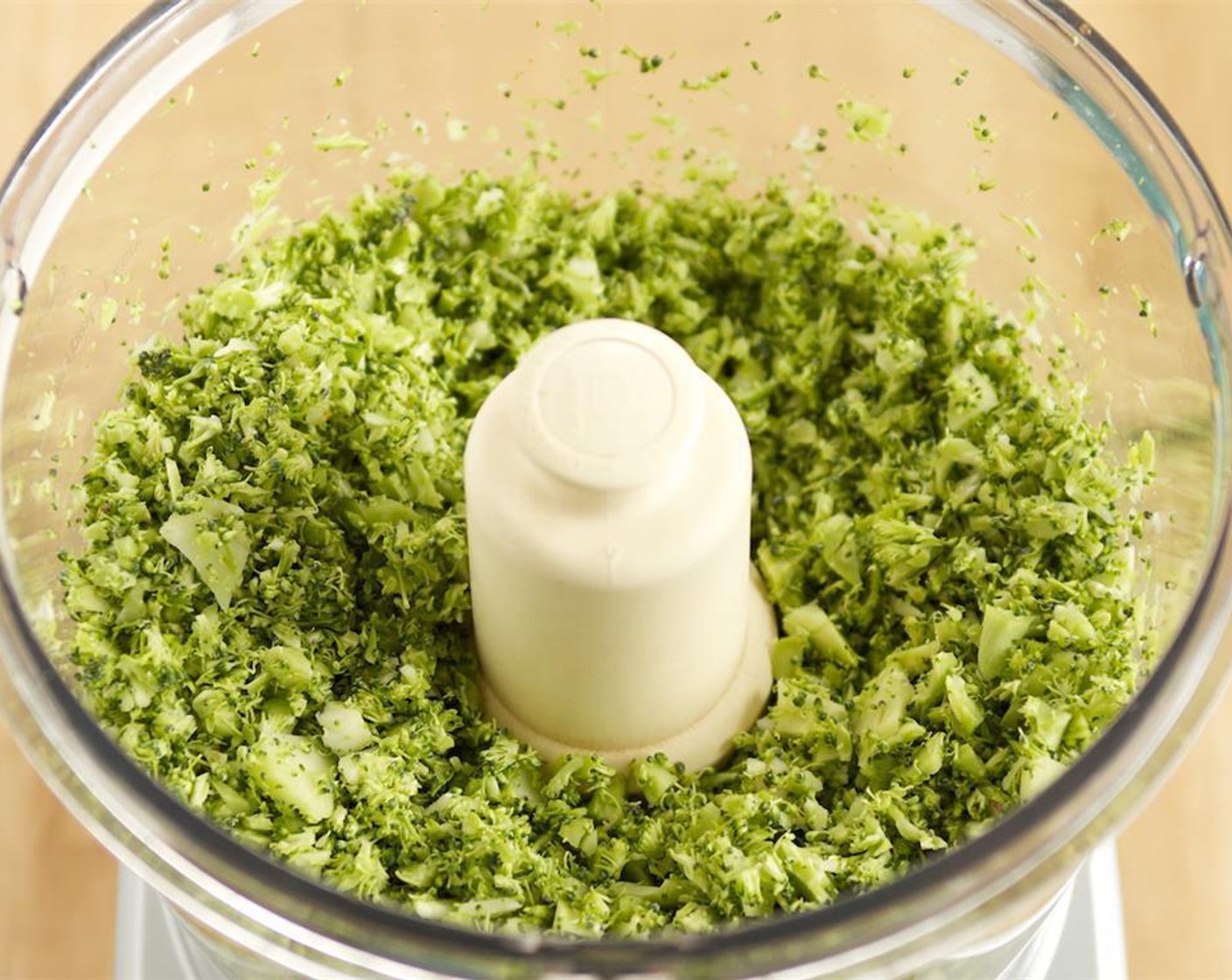 step 2 Place the broccoli crowns and peeled stems in a food processor fitted with a chopping blade and pulse in 2 batches until small bite-sized pieces remain. Set aside in a big bowl.