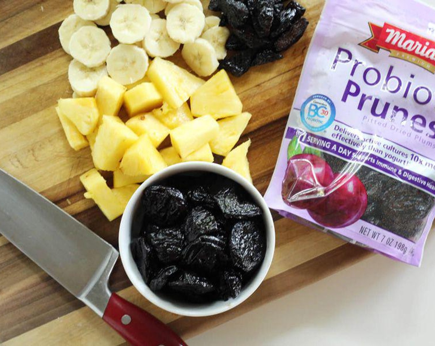 step 1 Add Ice (1/2 cup), Banana (1/2), Pineapple (1/2 cup), Probiotic Pitted Prunes (5), Greek Yogurt (4 Tbsp), and Pineapple Juice (1/2 cup) to a blender or smoothie cup. Blend until smooth.