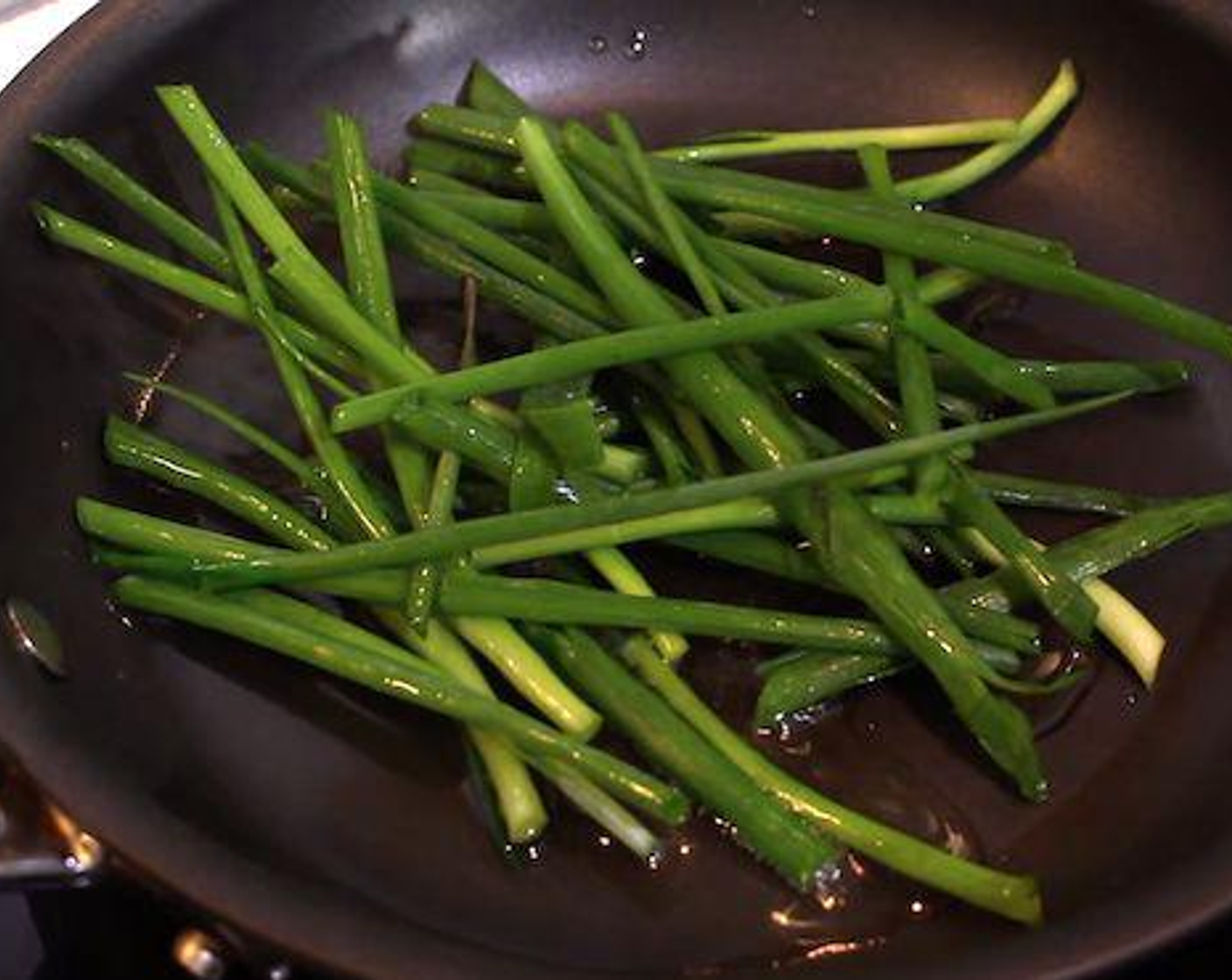 step 2 Heat Vegetable Oil (1/2 tsp) in a pan or wok over high heat and cook the Chinese Chives (1/3 cup) until wilted. Transfer the garlic chives into the bowl with the egg mixture.