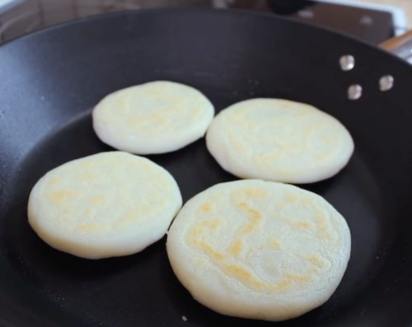 step 5 Flip and cook for another 10 minutes. Make sure the bottom is fully cooked before flipping to avoid sticking and breaking the arepa apart when flipping.