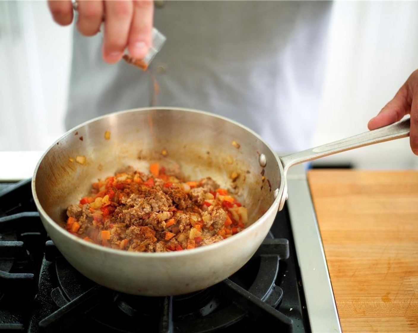 step 4 Break up the Ground Beef (8 oz) into small chunks with your hands and add to the pot; cook for 5 minutes, until the beef is mostly cooked.