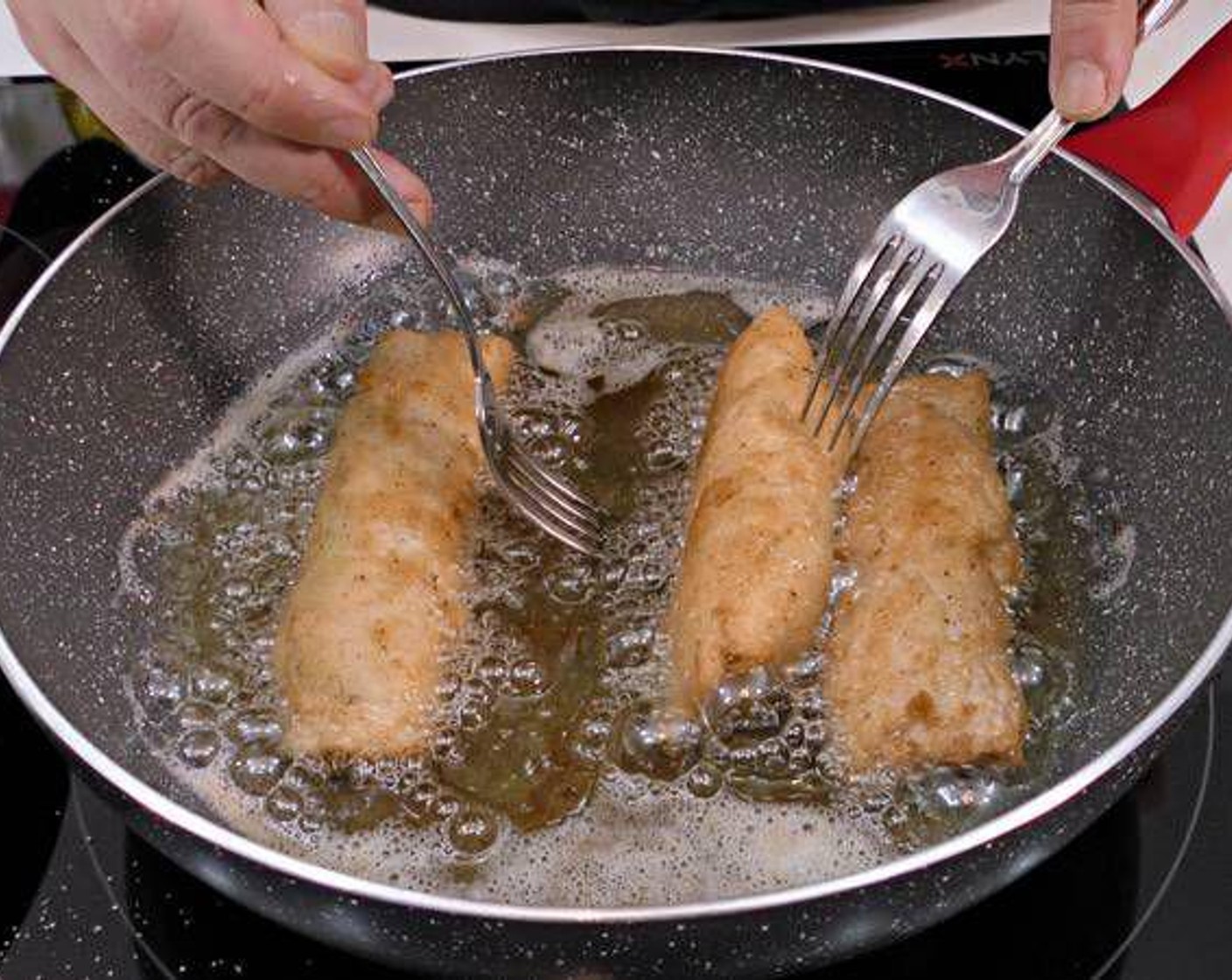 step 6 Once rolls are all coated and the oil is hot, fry them in batches on medium heat. Fry till they are cooked inside without burning outside.