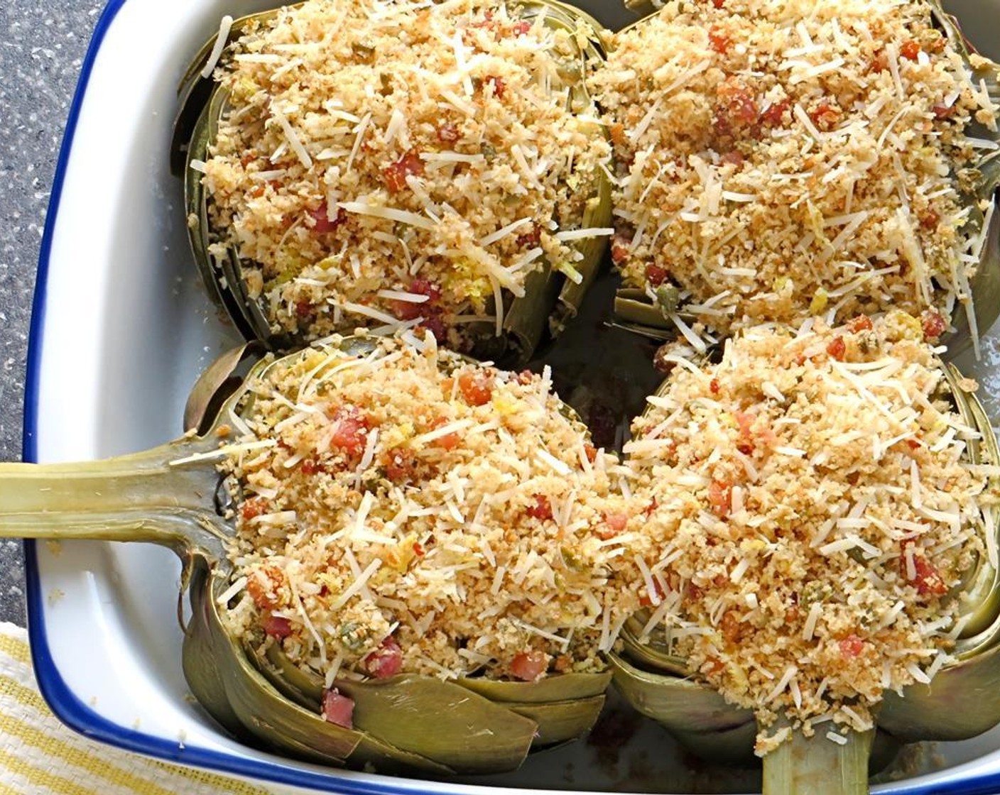 step 14 Carefully fill the artichoke cavity with the breadcrumb mixture. Place the artichokes under the broiler for 3-5 minutes until the filling is golden brown.