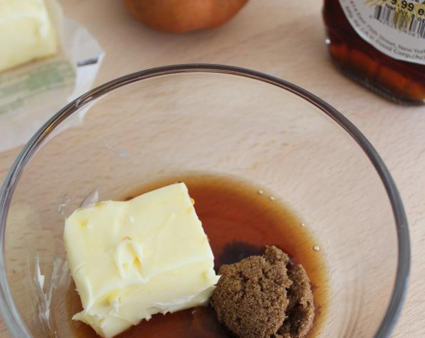 step 3 In a small bowl, combine the 3 tablespoons of Unsalted Butter , Maple Syrup (1 Tbsp), and Dark Brown Sugar (2 Tbsp) and stir to combine. Using a rubber spatula, spread the mixture evenly over the bottom of the pan.