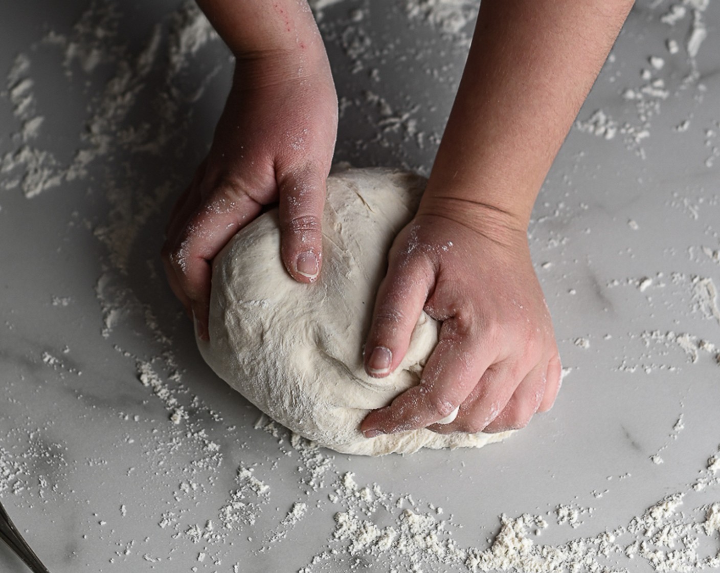 step 3 Using hands, mix the water into the flour until it forms a dough. Turn out onto a floured surface and knead until smooth.