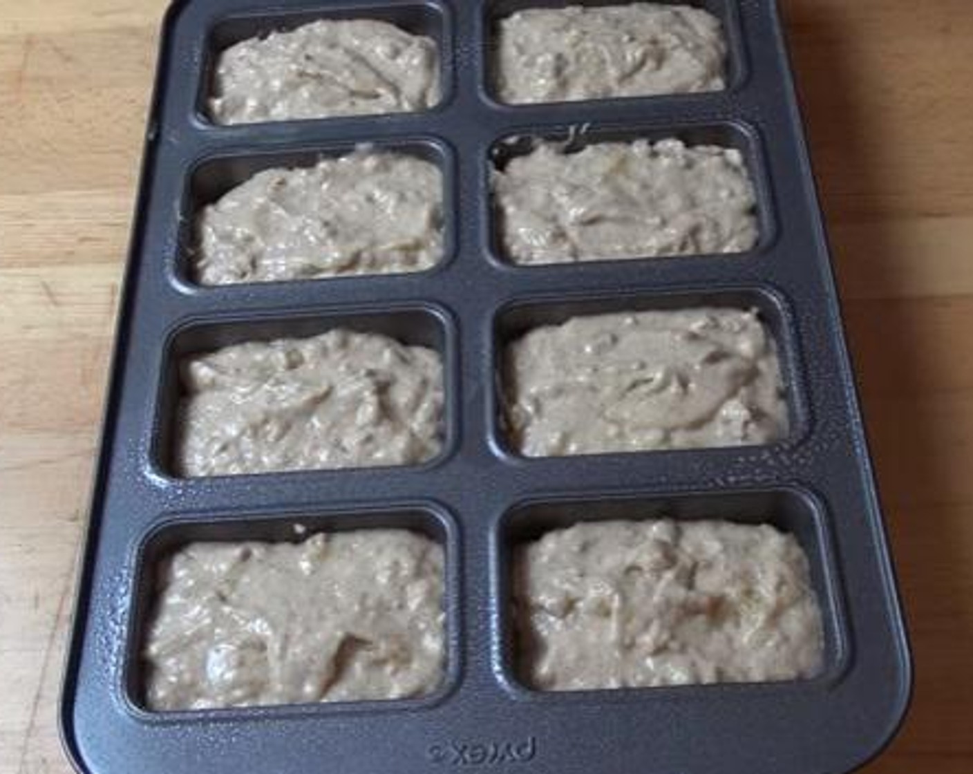 step 5 Divide the mixture among the holes of a loaf pan. Bake inside a preheated oven, at 350 degrees F (180 degrees C), for 25 minutes