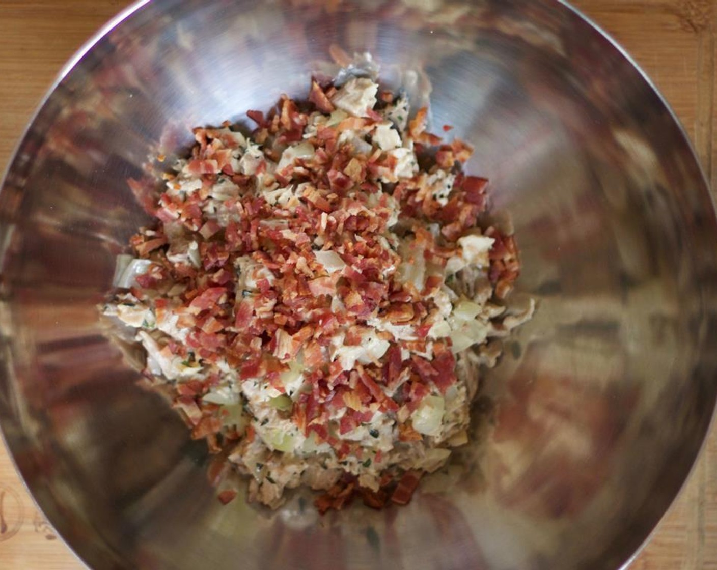 step 7 In a large mixing bowl, add the contents from the pan and the bacon. Cool for 15 minutes.