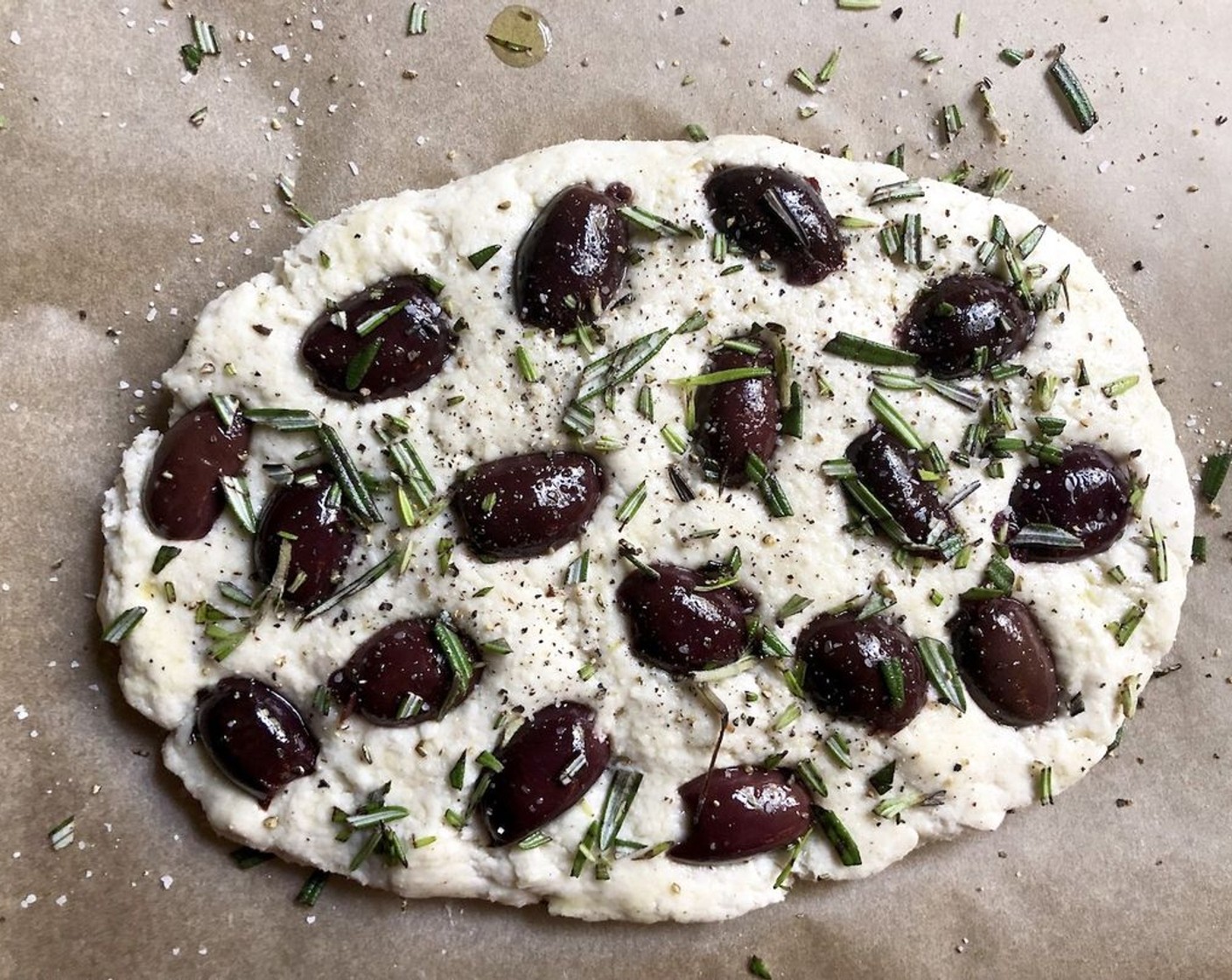 step 11 For the focaccia with olives and rosemary: Strew the Kalamata Olives (2 1/2 cups) over the surface of the dough. Allow some of the dough surface to show through the olives. Sprinkle with Fresh Rosemary (3/4 tsp). Season with Coarse Salt (to taste) and Freshly Ground Black Pepper (to taste). Finish with a light drizzle of Extra-Virgin Olive Oil (1 tsp).