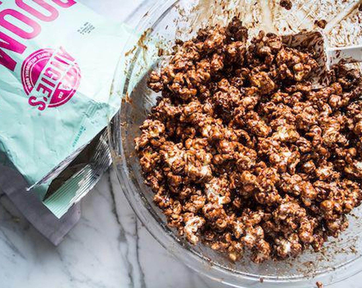 step 5 Once chocolate peanut butter mixture has cooled slightly, pour over popcorn in large bowl and use spatula to mix thoroughly until all popcorn is fully coated.