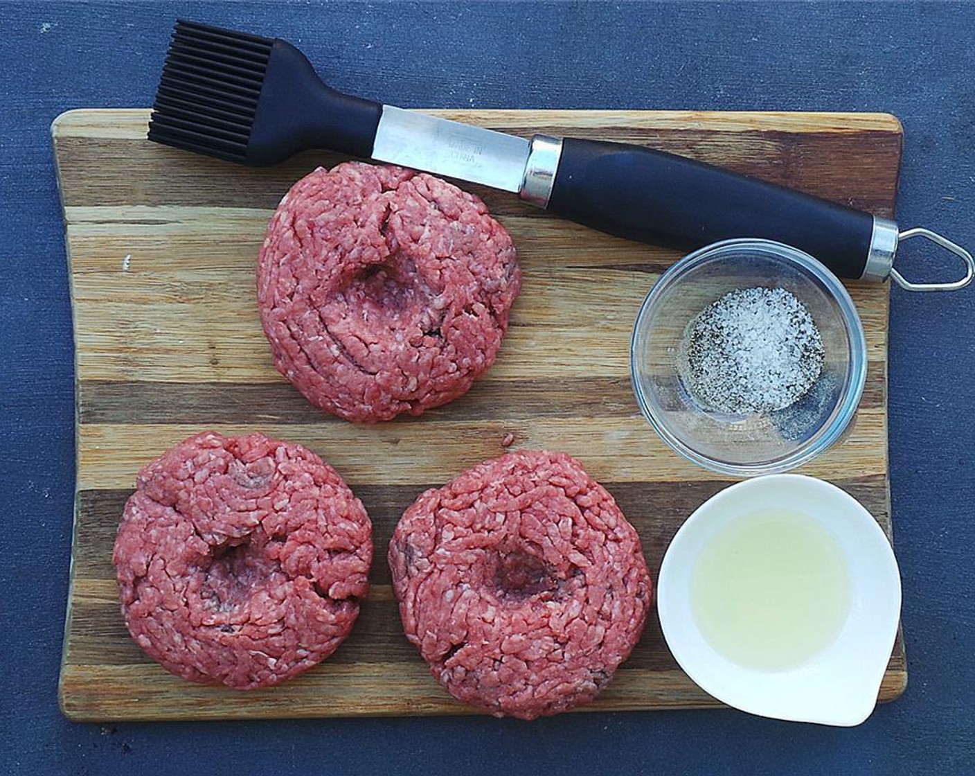 step 5 Brush each patty with Olive Oil (as needed) then generously season with Salt (to taste) and Ground Black Pepper (to taste).