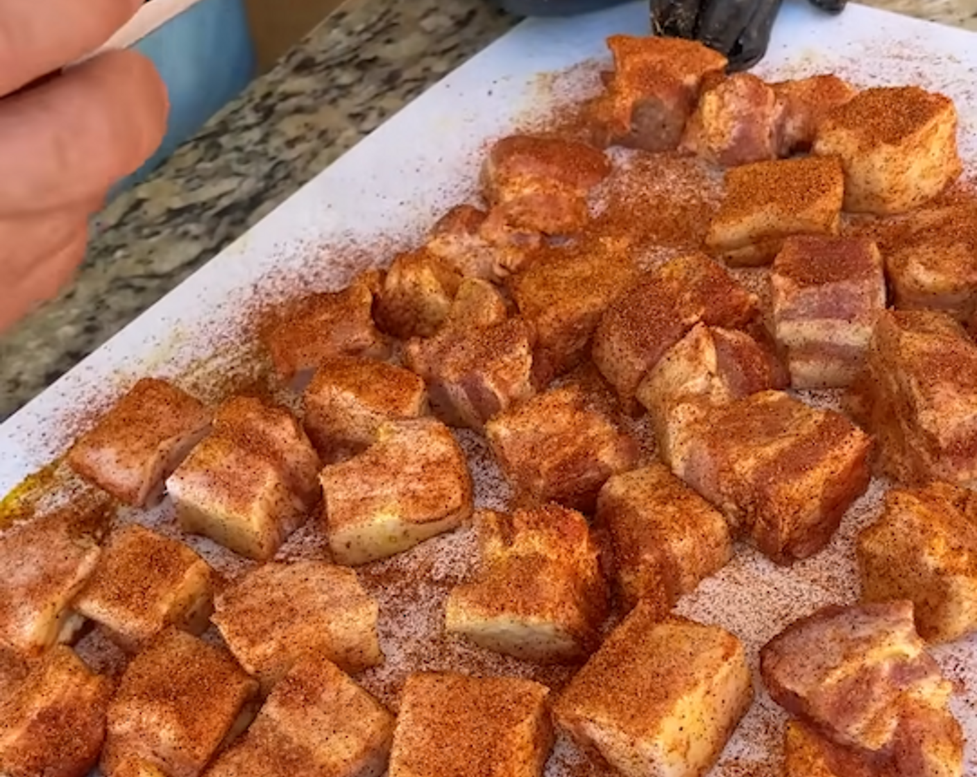 step 2 Cut Pork Belly (1) into cube-size portions, coat with Yellow Mustard (4 Tbsp), and season on all sides with Barbecue Rub (4 Tbsp).
