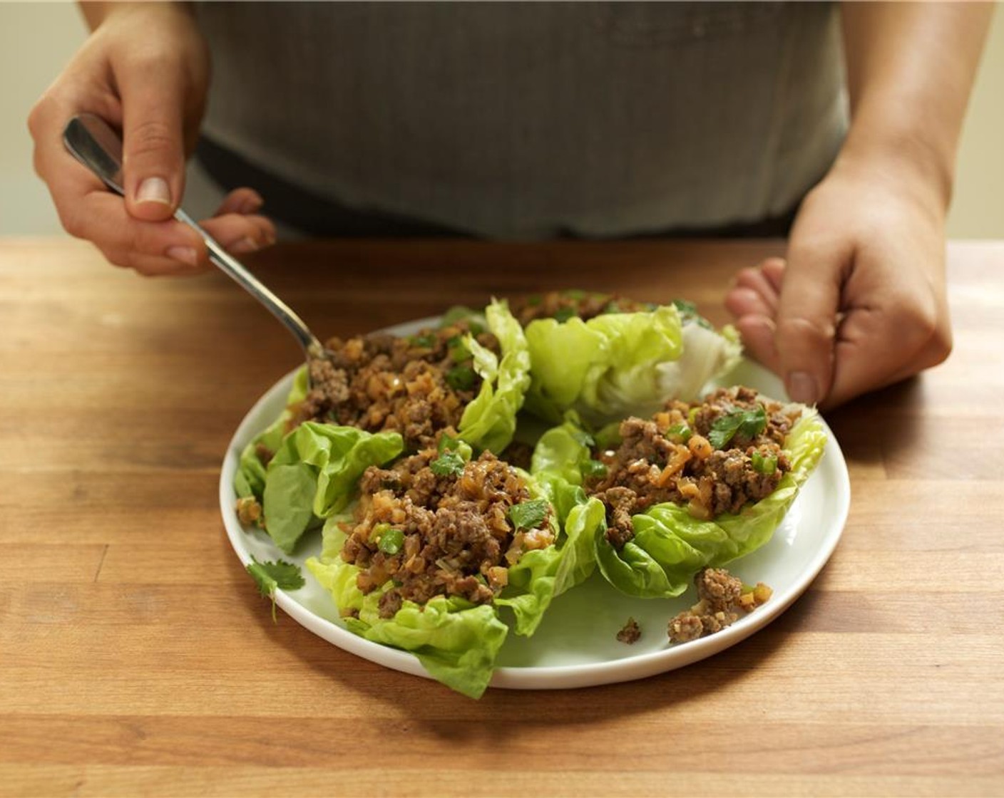 step 12 Place four Butter Lettuce (8) on each plate, and evenly distribute the beef mixture.